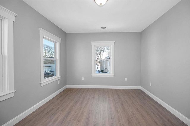 empty room with hardwood / wood-style floors