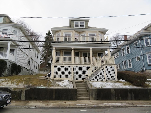 traditional style home featuring a porch and stairs