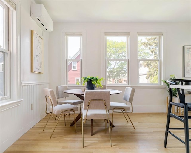 31 Kidder Ave Unit 31, Somerville, MA 02144 - dining room featuring a wall mounted air conditioner, plenty of natural light, light wood-style flooring, and wainscoting