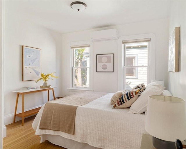 31 Kidder Ave Unit 31, Somerville, MA 02144 - bedroom with a wall mounted air conditioner and light wood finished floors