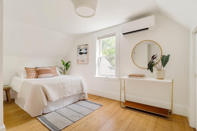 31 Kidder Ave Unit 31, Somerville, MA 02144 - bedroom featuring a wall mounted AC, vaulted ceiling, wood-type flooring, and baseboards