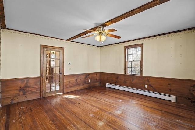 unfurnished room with ceiling fan, a baseboard radiator, and wood-type flooring