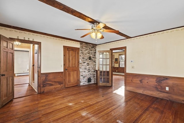 spare room featuring a baseboard heating unit, ceiling fan, and wood-type flooring