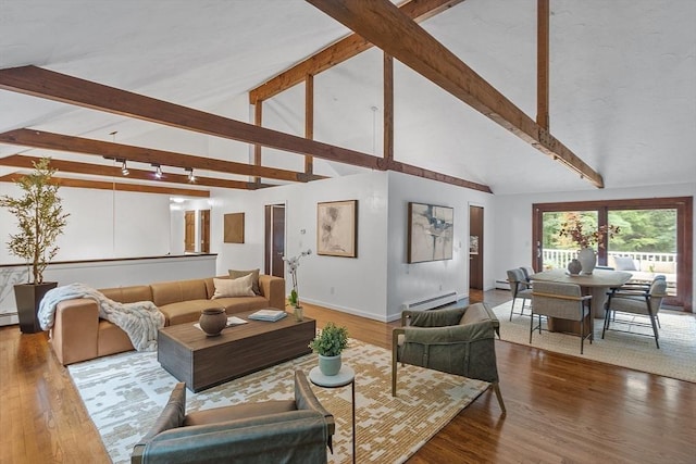 living room with a baseboard heating unit, beamed ceiling, and wood finished floors