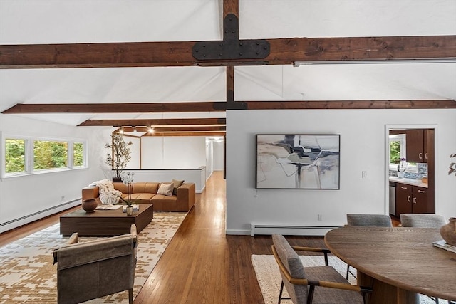 living room with a baseboard radiator, lofted ceiling with beams, and wood finished floors