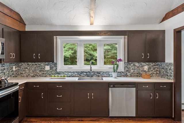 kitchen with light countertops, appliances with stainless steel finishes, and dark brown cabinetry