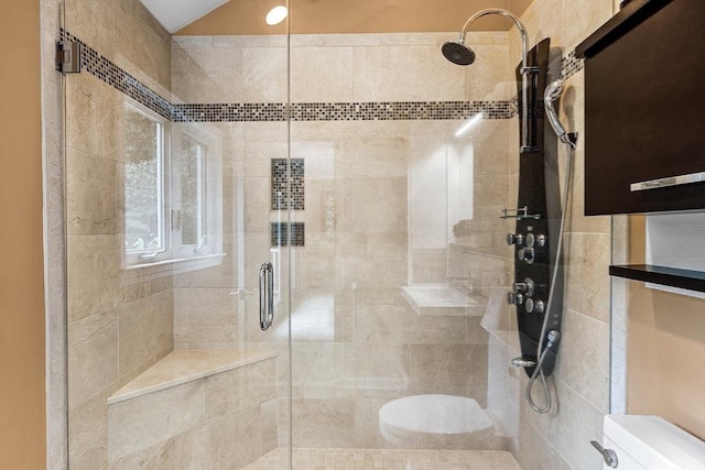 full bathroom featuring toilet, a stall shower, and lofted ceiling