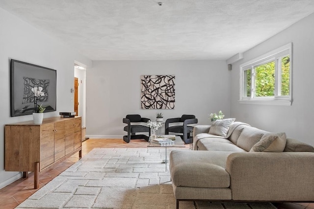 living room featuring baseboards and light tile patterned floors