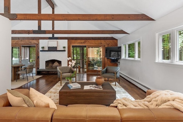 living area with a baseboard heating unit, a fireplace, wood finished floors, and vaulted ceiling with beams