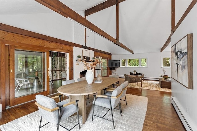 dining room featuring dark wood finished floors, baseboard heating, a fireplace, high vaulted ceiling, and beam ceiling