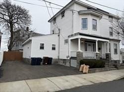 view of front of home with a porch and fence