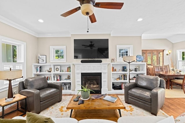 260 Beaver Dam Rd, Scituate, MA 02066 - living area with light wood-style flooring, a ceiling fan, recessed lighting, crown molding, and a glass covered fireplace