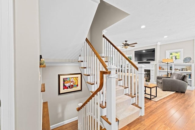 260 Beaver Dam Rd, Scituate, MA 02066 - stairway featuring hardwood / wood-style floors, a ceiling fan, a fireplace, recessed lighting, and crown molding