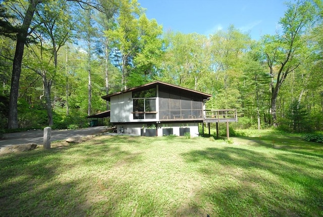 201 Annursnac Hill Rd, Concord, MA 01742 - rear view of property featuring a view of trees, a lawn, and a sunroom