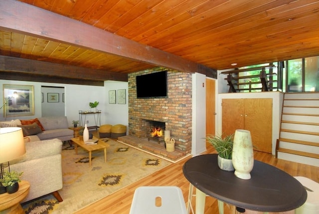 201 Annursnac Hill Rd, Concord, MA 01742 - living area with wood finished floors, beam ceiling, a fireplace, wooden ceiling, and stairway