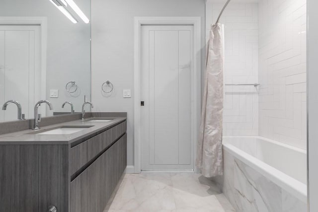 bathroom featuring a combined bath / shower with marble appearance, a sink, marble finish floor, and double vanity