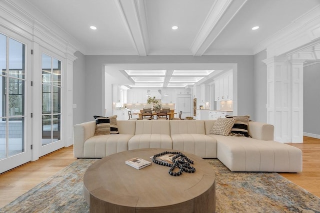 living area featuring light wood-style flooring, crown molding, beamed ceiling, and recessed lighting