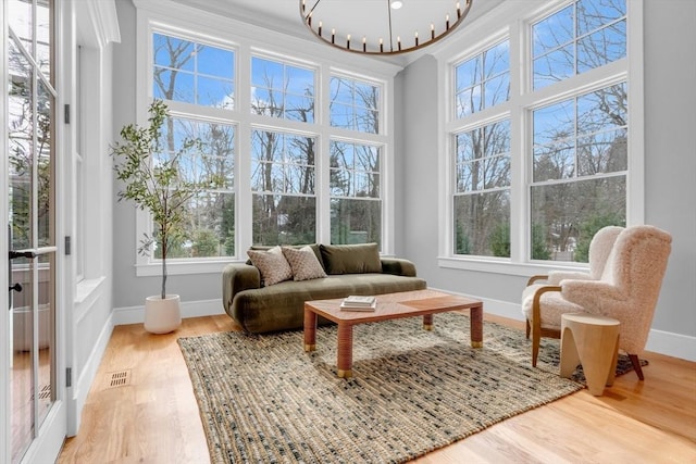 sunroom featuring a chandelier