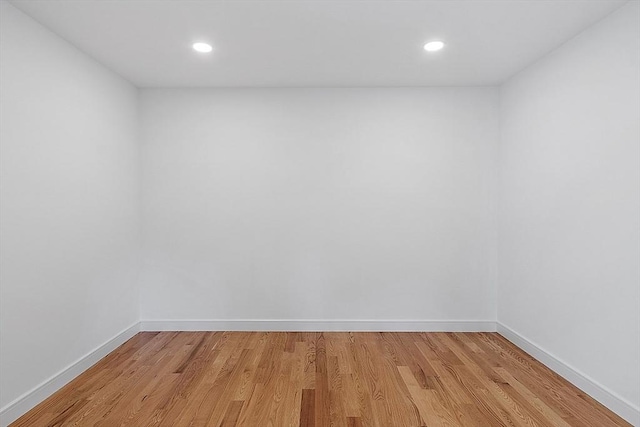 unfurnished room with light wood-type flooring, baseboards, and recessed lighting