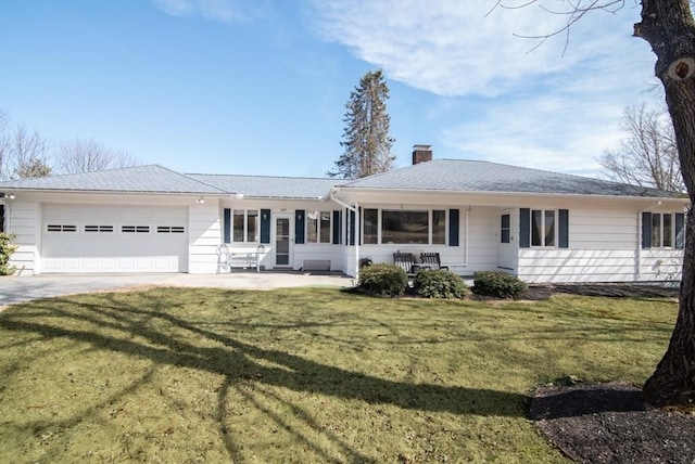 view of front of property featuring a front yard, roof with shingles, a chimney, concrete driveway, and a garage