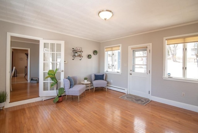 entryway featuring crown molding, baseboards, wood-type flooring, and a baseboard radiator