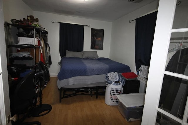 bedroom with visible vents and wood finished floors