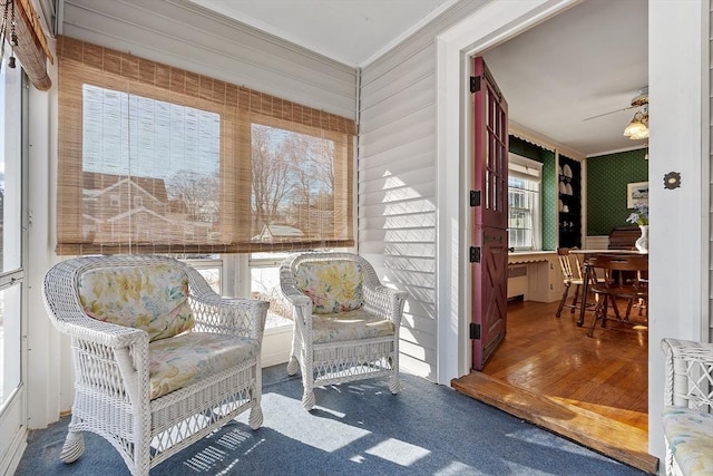 sunroom / solarium featuring ceiling fan