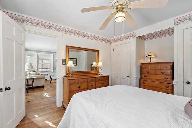 bedroom featuring light wood finished floors and ceiling fan