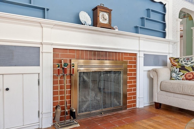 details with a fireplace and wood finished floors