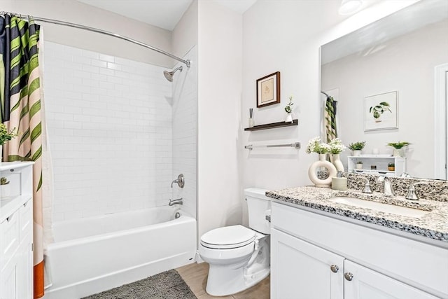 full bathroom featuring toilet, shower / bathtub combination with curtain, and vanity