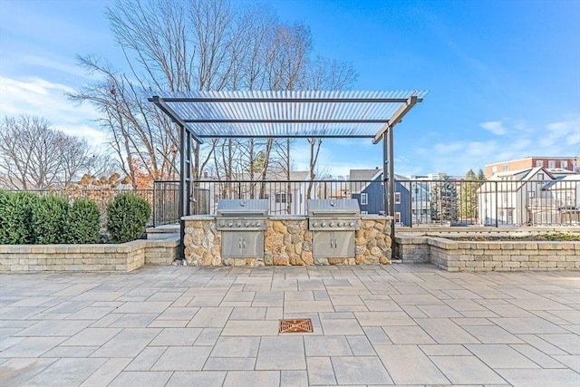 view of patio with an outdoor kitchen, a pergola, and a grill