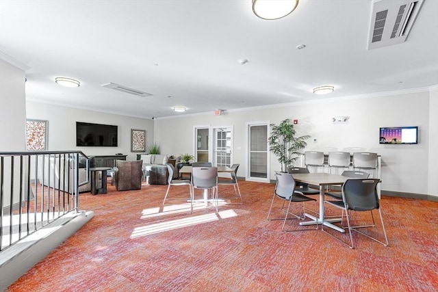 dining area featuring crown molding and carpet flooring