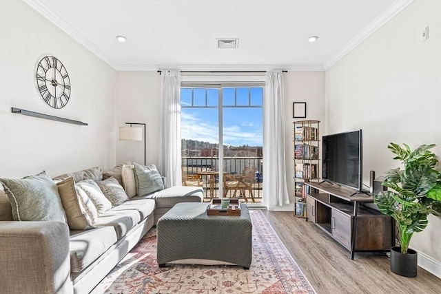 living room with light wood-type flooring and crown molding