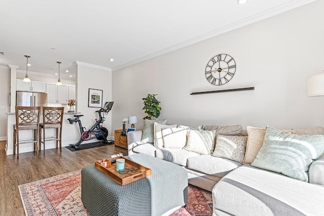 living room featuring dark wood-type flooring and ornamental molding