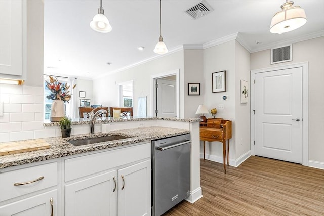 kitchen featuring dishwasher, white cabinetry, sink, hanging light fixtures, and light stone counters