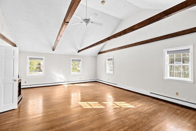 unfurnished living room with ceiling fan, a baseboard radiator, lofted ceiling with beams, and hardwood / wood-style floors