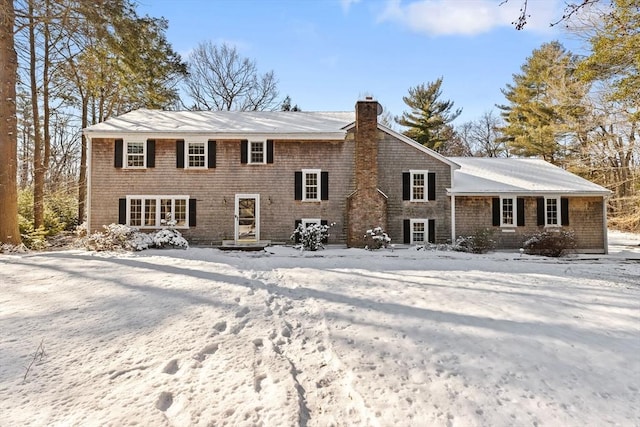 view of snow covered rear of property