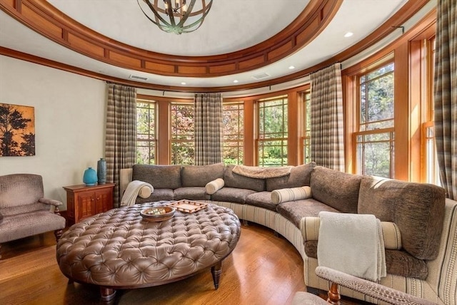 sitting room featuring crown molding, wood-type flooring, and a wealth of natural light