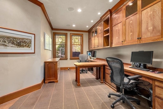 office area featuring ornamental molding and built in desk