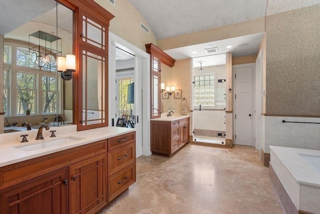 bathroom with vanity, a tub to relax in, a notable chandelier, and tile walls