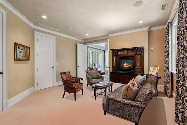 living area with crown molding and light colored carpet