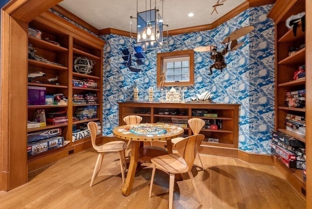 wine cellar featuring an inviting chandelier, crown molding, and light hardwood / wood-style floors