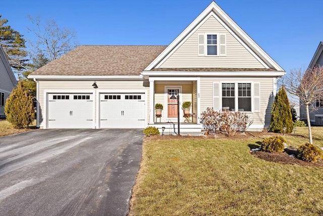 view of front of home with a garage and a front lawn