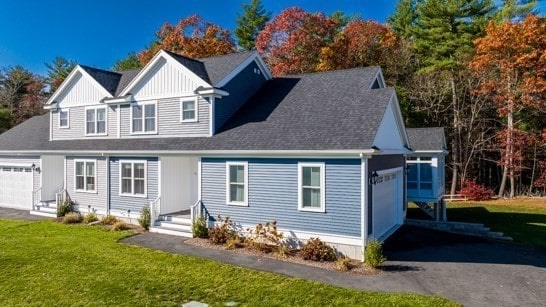 view of front of property with a garage and a front yard