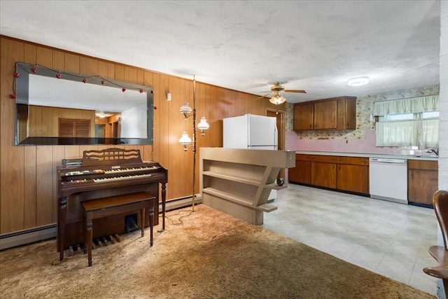 33 Clara Rd, Brockton, MA 02302 - kitchen featuring white appliances, brown cabinetry, wooden walls, a baseboard radiator, and a ceiling fan