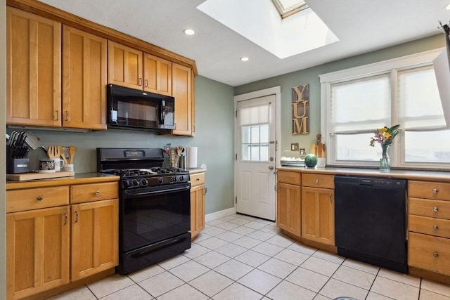 33 Argyle Rd Unit 33, Braintree, MA 02184 - kitchen with black appliances, a skylight, recessed lighting, light tile patterned floors, and light countertops