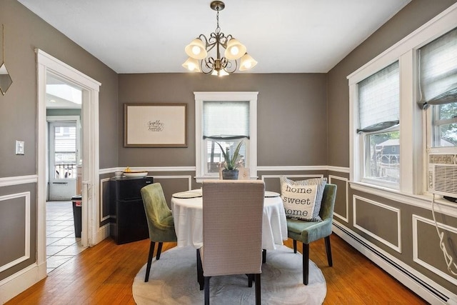 33 Argyle Rd Unit 33, Braintree, MA 02184 - dining space with baseboard heating, a chandelier, wood finished floors, and wainscoting