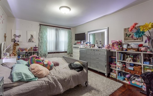 bedroom with dark hardwood / wood-style flooring and ornamental molding