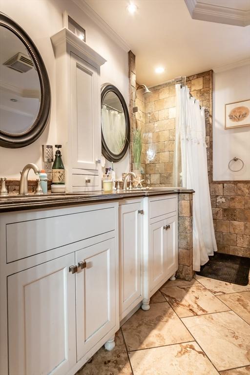 bathroom with vanity, a shower with curtain, and ornamental molding