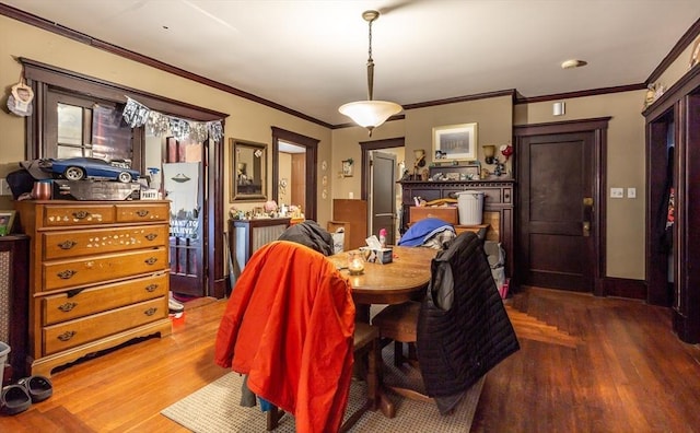 dining room featuring wood-type flooring and ornamental molding